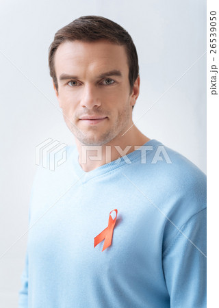 Good looking confident man wearing red AIDS ribbon Good looking confident man wearing red AIDS ribbon 26539050