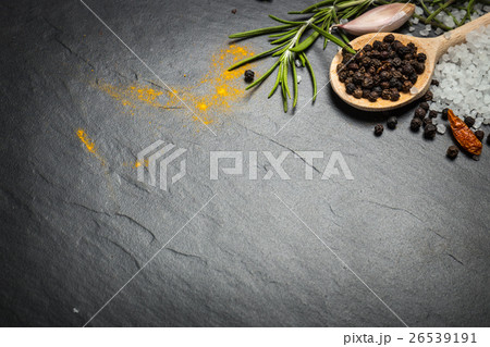 spices and herbs over black stone background 26539191