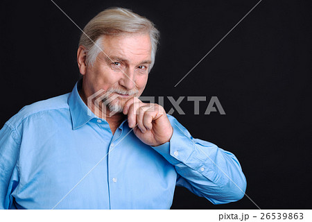 Smiling pensioner holding his hand on the beard Smiling pensioner holding his hand on the beard 26539863
