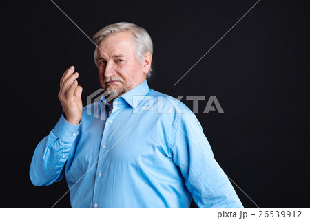 Very serious pensioner looking at camera Very serious pensioner looking at camera 26539912