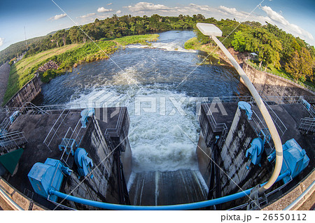 Water flowing from the open sluice gates of dam. 26550112