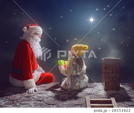 girl and Santa Claus sitting on the roof 26553922