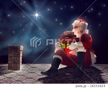 Santa Claus sitting on the roof 26553924
