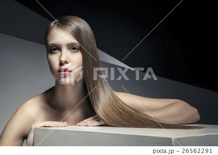 Calm young woman with  shiny hair looking away 26562291
