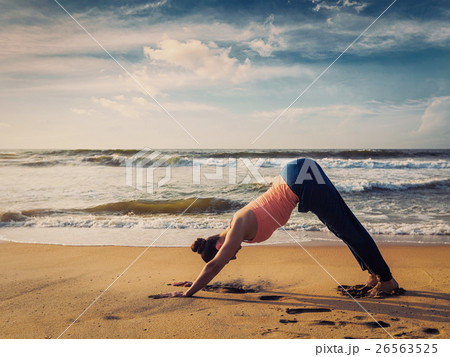 Young sporty fit woman doing yoga oudoors at Young sporty fit woman doing yoga oudoors at 26563525