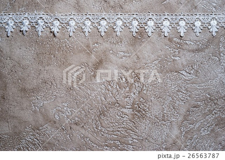 white lace border on a beige cement background white lace border on a beige cement background 26563787