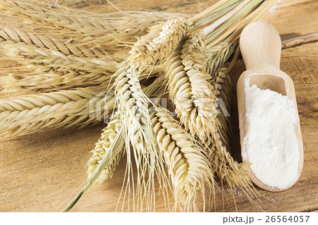 Flour in bag and wheat ears on a wooden background 26564057