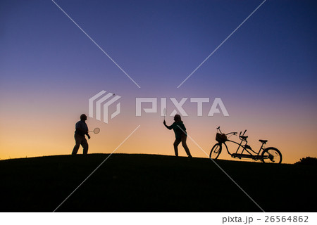 Couple is playing badminton. 26564862