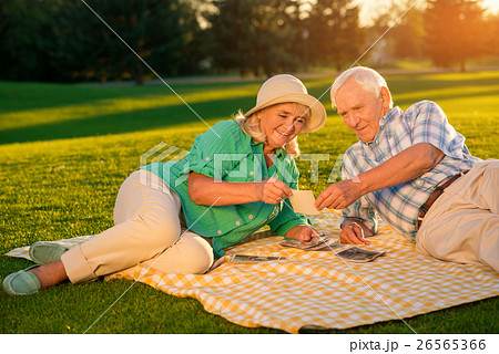 Senior people lying on meadow. 26565366