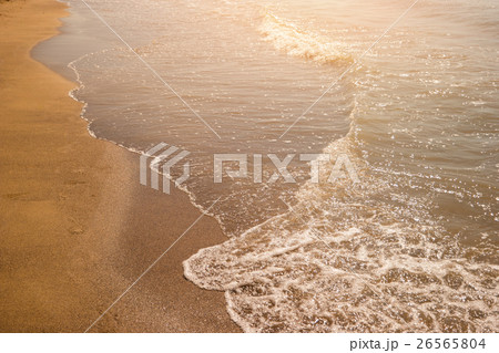 Foamy water on a shore. 26565804