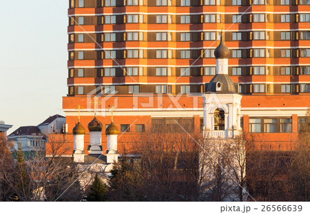 Orthodox church and belfry on the hotel background Orthodox church and belfry on the hotel background 26566639