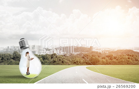 Businesswoman inside light bulb Businesswoman inside light bulb 26569200