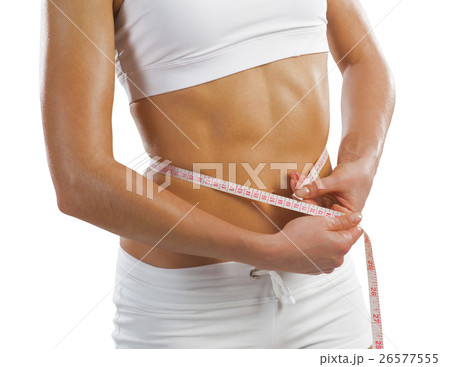 young athletic woman measuring waist 26577555