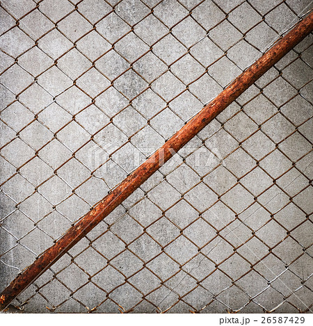 rusty iron chain wire fence on cement wall rusty iron chain wire fence on cement wall 26587429
