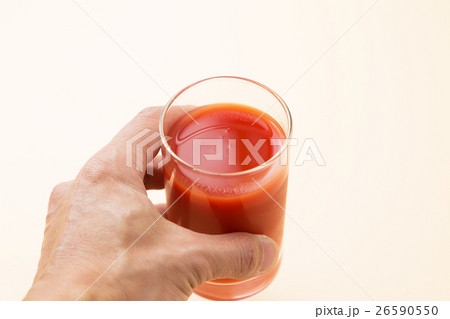トマトジュース 野菜ジュース オレンジバックの写真素材