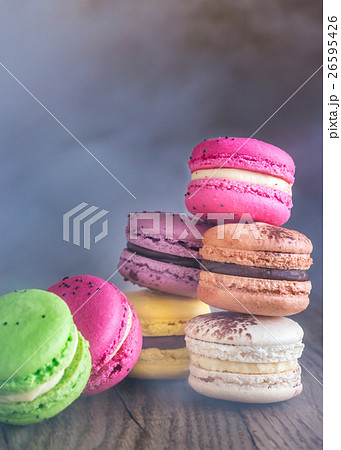 Colorful macarons on the wooden background 26595426