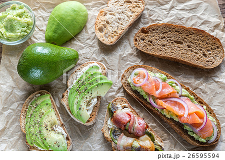 Toasts with avocado and different toppings Toasts with avocado and different toppings 26595594