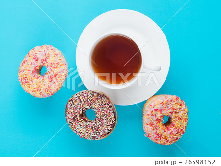 Cup of tea for breakfast with donuts in motion Cup of tea for breakfast with donuts in motion 26598152