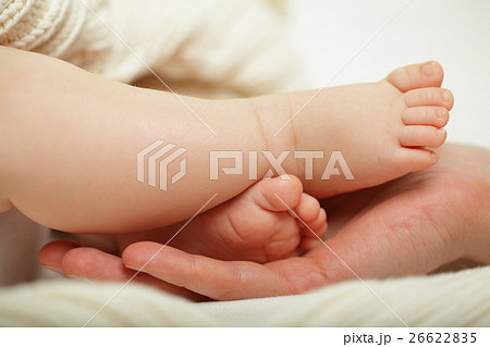 Small baby foot in father's hand, macro Small baby foot in father's hand, macro 26622835
