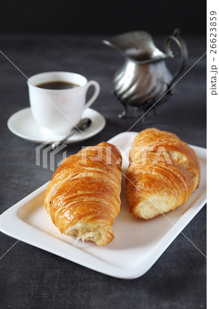 Two fresh croissants and cup of coffee  26623859