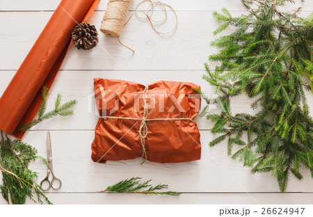 Wrapping christmas present gift on white wood 26624947
