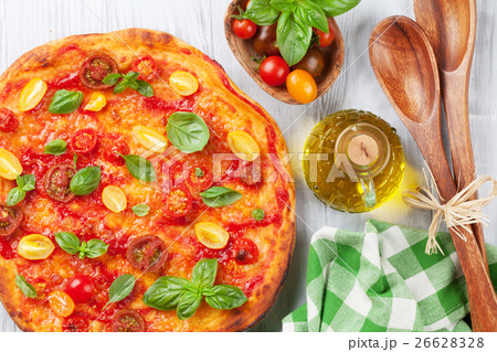 Pizza with tomatoes, mozzarella and basil 26628328