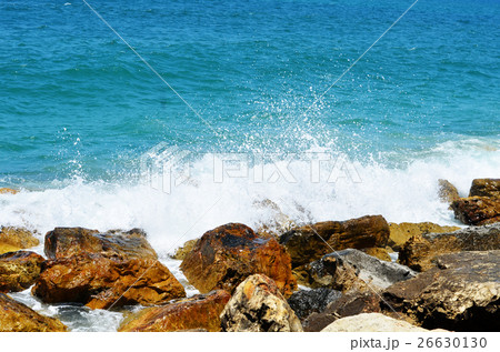 Sea waves break about stones 26630130