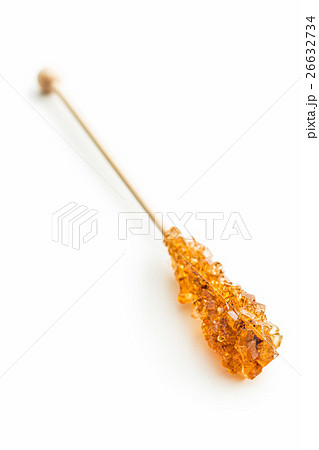 Brown amber sugar crystal on wooden stick. Brown amber sugar crystal on wooden stick. 26632734