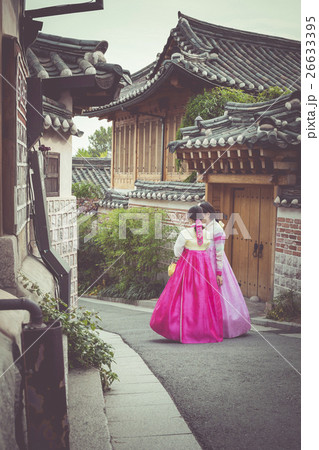 A couple women in Bukchon Hanok Village in Seoul A couple women in Bukchon Hanok Village in Seoul 26633395