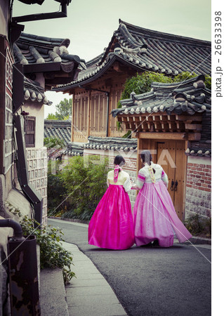 A couple women in Bukchon Hanok Village in Seoul A couple women in Bukchon Hanok Village in Seoul 26633398