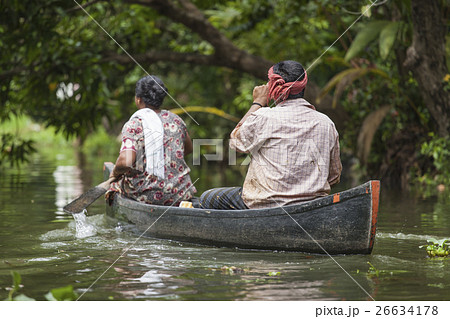 Unidentified indian people in small boat in backwa 26634178