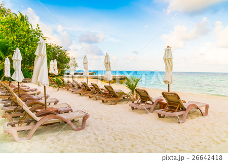 Beach chairs with umbrella at Maldives island, white sandy beach and sea . Beach chairs with umbrella at Maldives island, white sandy beach and sea . 26642418