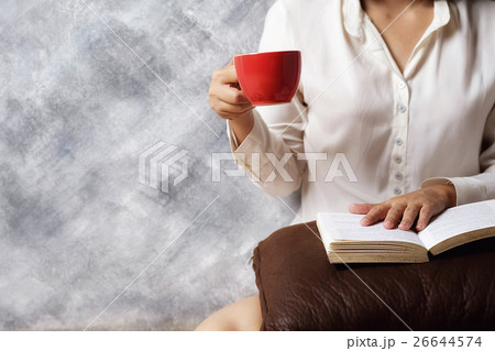 beautiful female sitting on the floor and reading  26644574