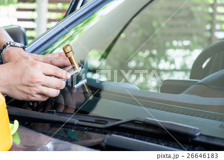 Glazier using tools repair to fix crack windshield 26646183