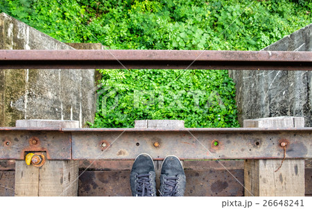 Black sneaker on wooden old railroad Black sneaker on wooden old railroad 26648241