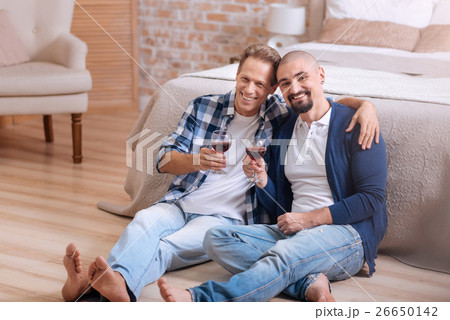 Smiling homosexual couple drinking wine in the Smiling homosexual couple drinking wine in the 26650142