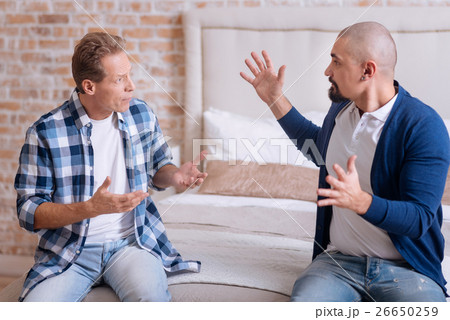 Irritated gay couple quarrelling at home Irritated gay couple quarrelling at home 26650259