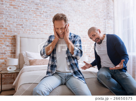 Choleric man screaming loudly on another person at Choleric man screaming loudly on another person at 26650375