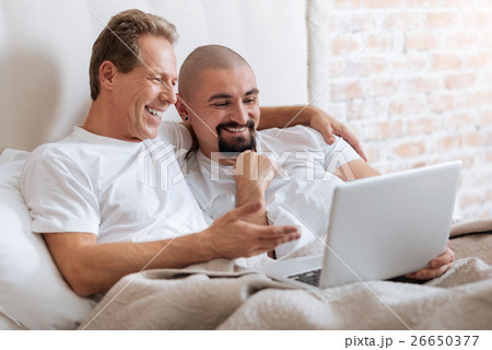 Delighted non-traditional couple lying in the bed Delighted non-traditional couple lying in the bed 26650377