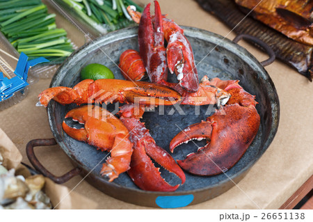 Plenty of seafood, roasted lobster claws on grill 26651138