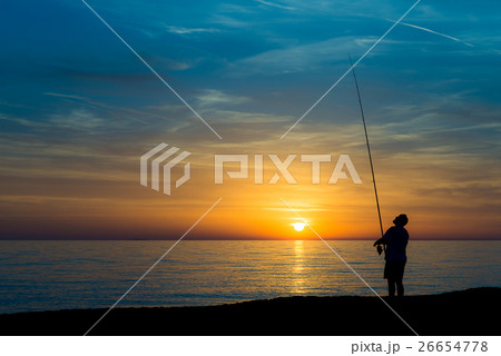 Fisherman on the beach at sunset 26654778