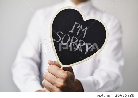 man with a signboard with the text I am sorry 26655539