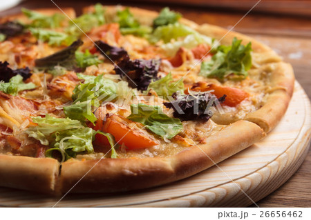 Caesar pizza on messy wooden background. Caesar pizza on messy wooden background. 26656462