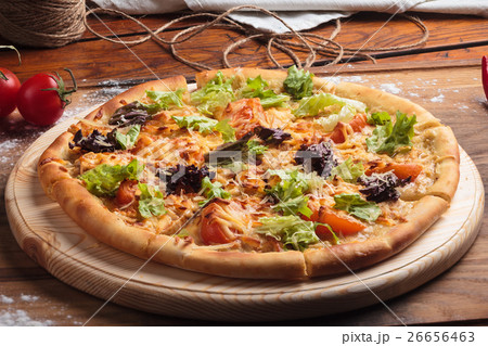 Caesar pizza on messy wooden background. 26656463
