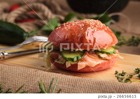 Trendy glossy burger with salmon in pink bun Trendy glossy burger with salmon in pink bun 26656615