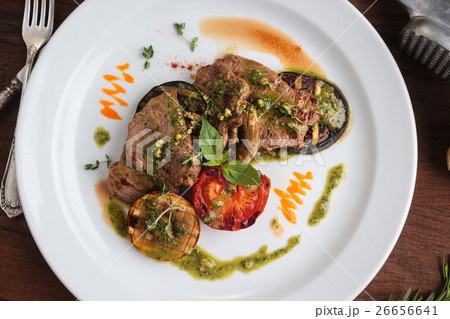 veal medallions with grilled vegetables 26656641