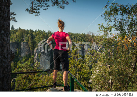Young woman and her dog enjoy mountain hikes  Young woman and her dog enjoy mountain hikes  26660482
