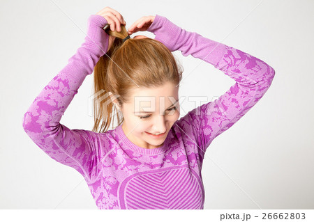 girl collecting hair in a ponytail on the gum girl collecting hair in a ponytail on the gum 26662803