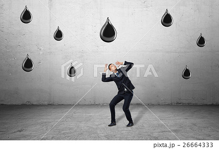 Businessman in full growth protects himself Businessman in full growth protects himself 26664333