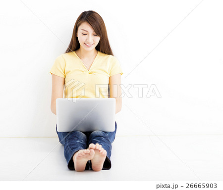 Smiling seated young woman with laptop Smiling seated young woman with laptop 26665903